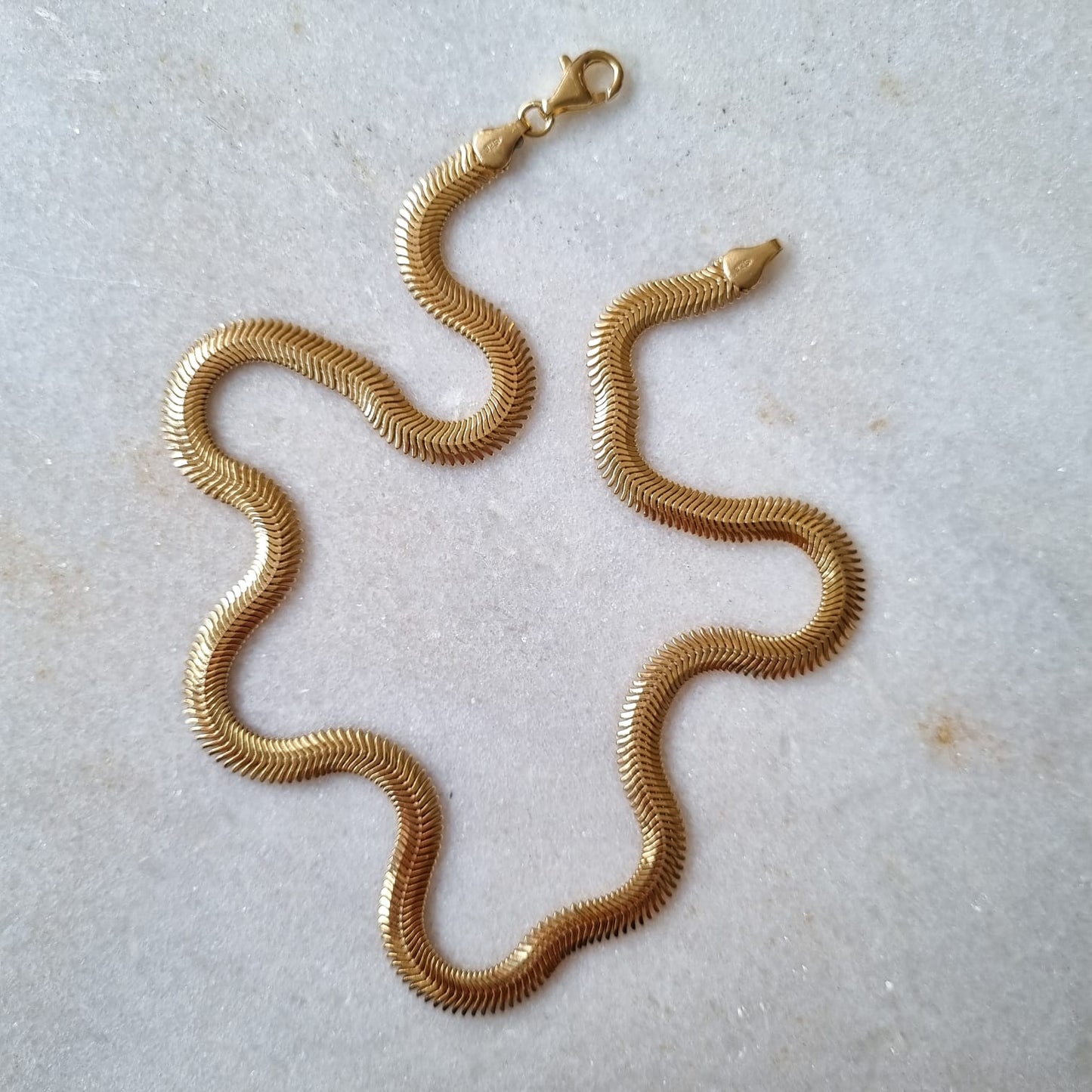 SNAKE BONE CHAIN close-up showing detailed snake chain texture and gold plating